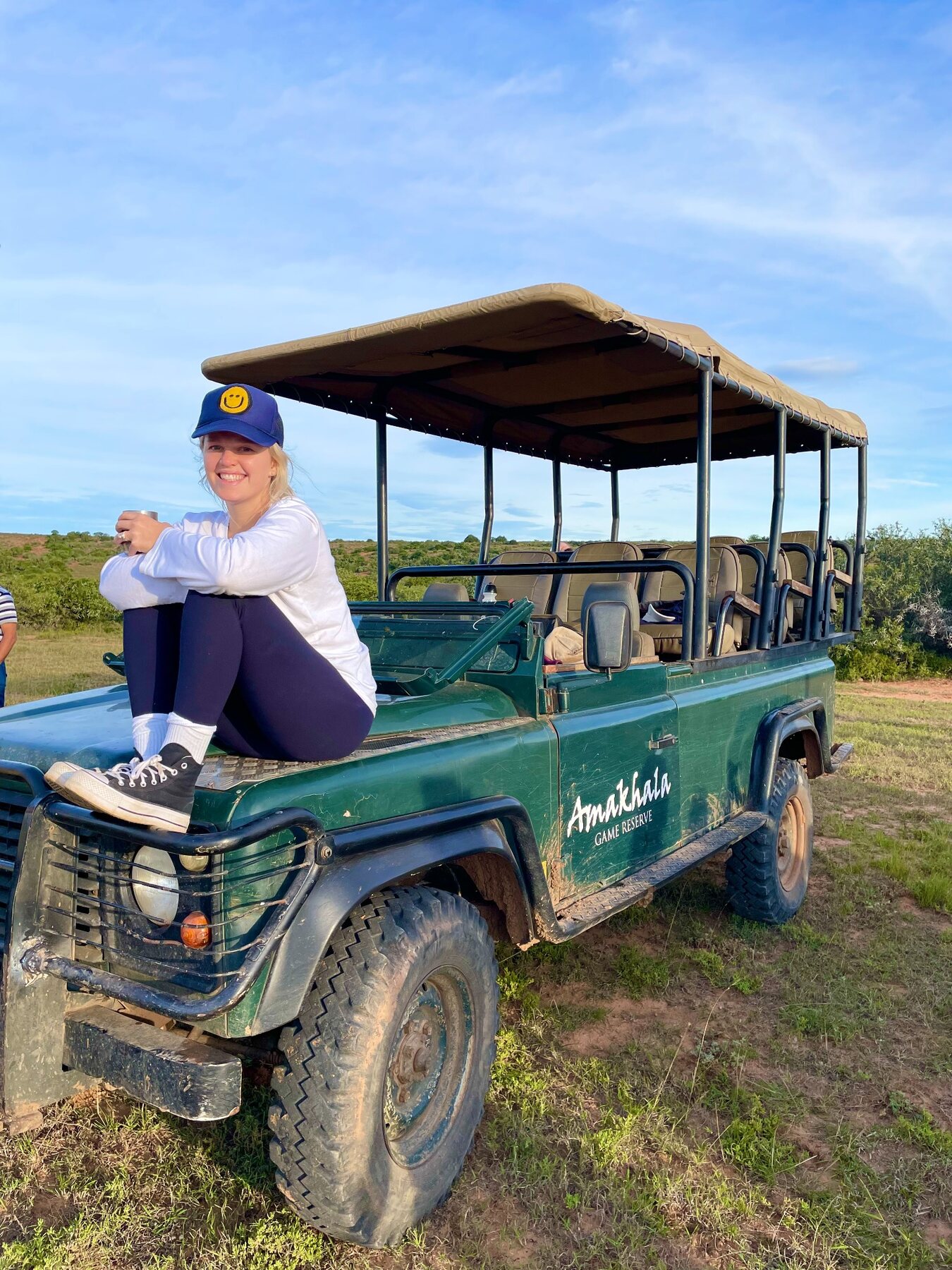Robyn smiling on an outdoor safari vehicle